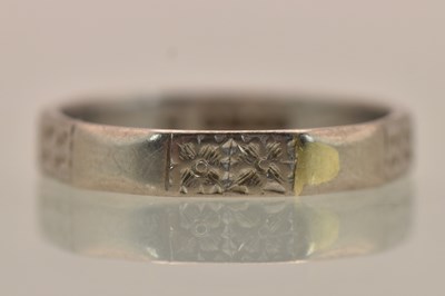 Lot 1295 - An 18ct white gold band ring with flat...
