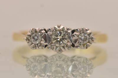 Lot 1287 - An 18ct yellow gold diamond three stone ring,...