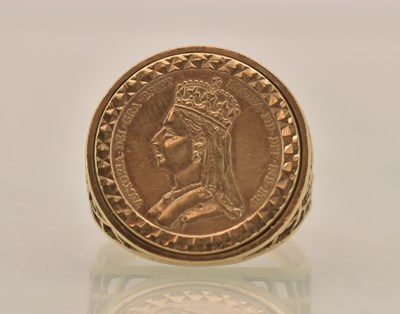 Lot 1305 - A 9ct yellow gold sovereign type ring, the...