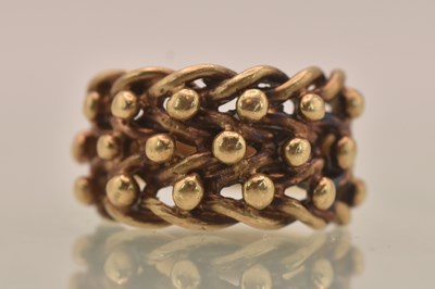 Lot 1297 - A 9ct yellow gold woven 'knot' type ring, size...