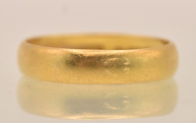 Lot 1299 - A 22ct yellow gold band ring, size J/K, approx...