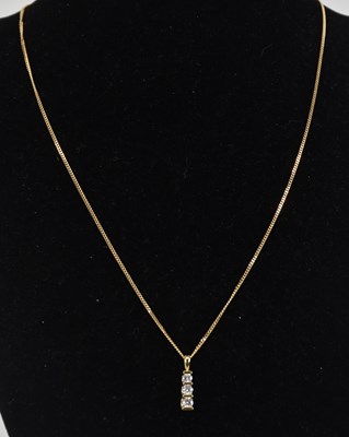 Lot 1383 - A three stone diamond set necklace pendant,...