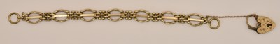 Lot 1501 - A 9ct yellow gold oval and three bar gate link...