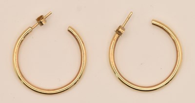 Lot 1444 - A pair of yellow metal hoop earrings, testing...