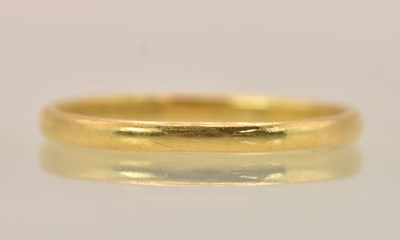 Lot 1280 - A 22ct gold thin band ring, (misshapen), size...