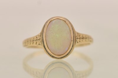 Lot 1347 - A 14ct yellow gold opal ring, the bezel set...