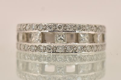 Lot 1249 - A contemporary 18ct white gold half eternity...