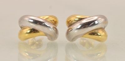 Lot 1447 - A pair of 18ct two-tone gold earrings with a...