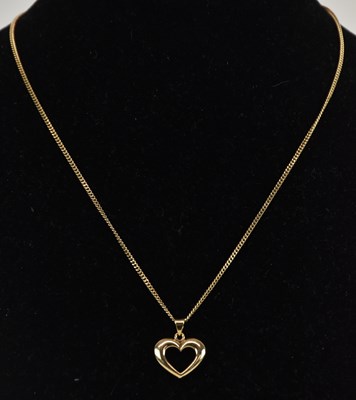 Lot 1406 - A 9ct yellow gold open small heart pendant, on...