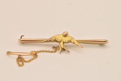 Lot 1478 - A 9ct yellow gold bar brooch with swallow to...