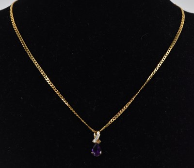 Lot 1411 - A claw set pear shaped amethyst drop in a 9ct...