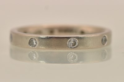 Lot 1319 - A white gold diamond set eternity ring, size L,...