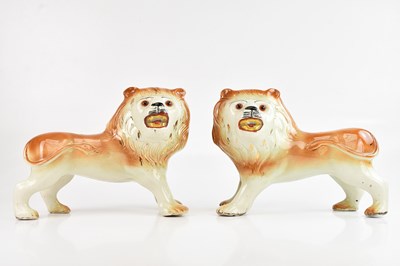 Lot 1263 - A pair of 19th century Staffordshire lions,...