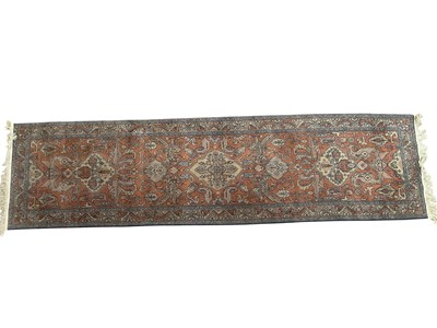 Lot 2173 - An orange ground hand knitted woolen eastern...