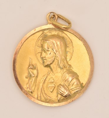 Lot 1390 - A circular yellow metal pendant depicting...