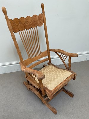 Lot 77 - An early 20th century oak rocking chair.