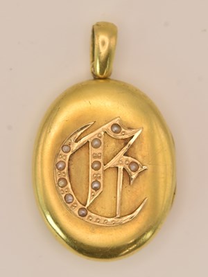 Lot 1391 - A Victorian yellow metal oval locket pendant,...