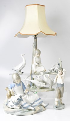 Lot 223 - LLADRÓ; a table lamp in the form of a boy...