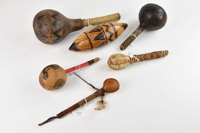 Lot 1125 - A collection of rattles comprising four...