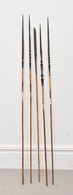 Lot 1179 - A group of four Papua New Guinea barbed spears,...