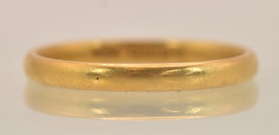 Lot 1266 - A 22ct yellow gold band ring, size P, approx 2....