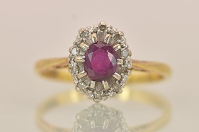 Lot 1283 - An 18ct yellow gold and platinum ruby and...