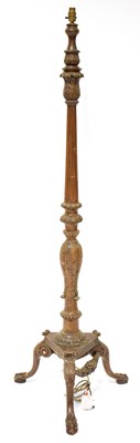 Lot 203 - A wooden standard lamp with carved decoration...