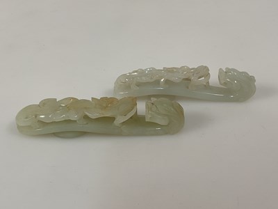 Lot 26 - A Chinese white jade figural belt buckle...
