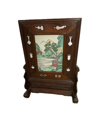 Lot 28 - A Chinese rosewood table screen, the central...