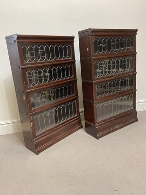 Lot 2004 - GLOBE WERNICKE; two oak four section bookcases,...