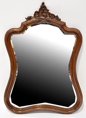 Lot 186 - A mahogany shaped wall mirror, with carved...