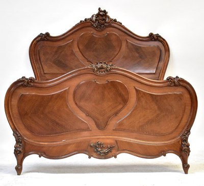 Lot 151 - A French mahogany double bedstead with carved...