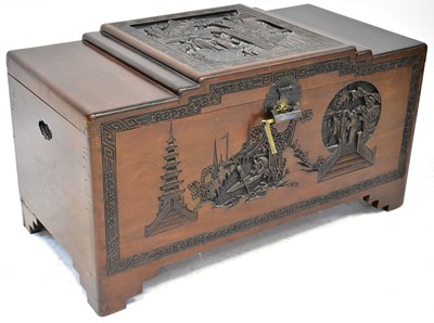 Lot 141 - A carved camphorwood chest, the lid carved...