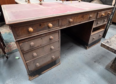 Lot 23 - A nine-drawer partner's desk, with red leather-...