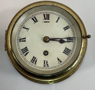 Lot 235 - A brass ship's bulkhead clock with Roman...