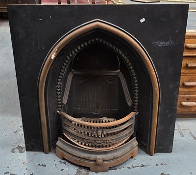 Lot 39 - A black and gold painted cast iron fire insert,...