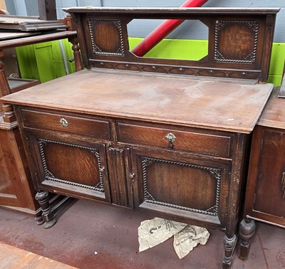 Lot 43 - An early 20th century oak mirror back...