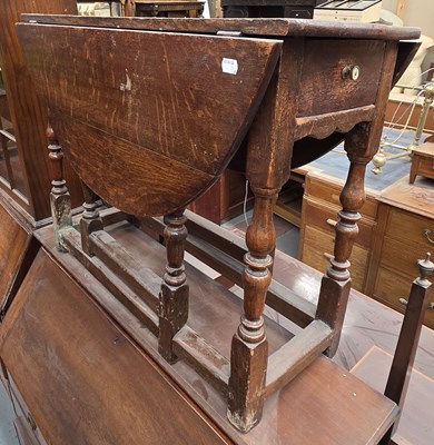 Lot 59 - A 19th century oak drop-leaf table for...