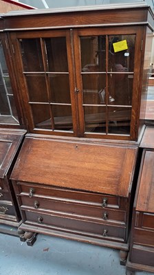 Lot 61 - An early 20th century oak bureau bookcase, the...