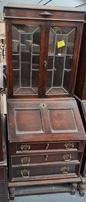 Lot 62 - An early 20th century oak bureau bookcase, the...
