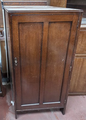 Lot 66 - An early 20th century oak low hall robe, the...