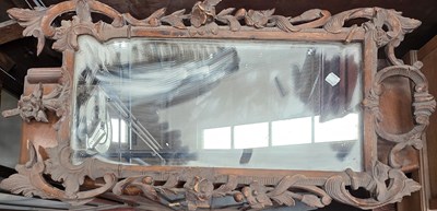 Lot 81 - A rectangular wall mirror with carved frame...