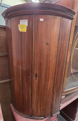 Lot 87 - A Georgian mahogany bow-front line inlaid wall...
