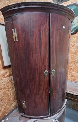 Lot 94 - A Georgian mahogany bow-fronted two-door...