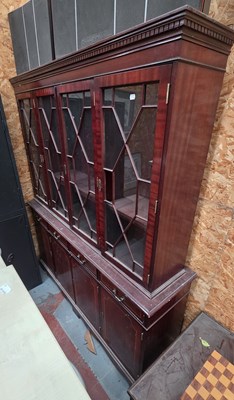 Lot 100 - A reproduction mahogany bookcase, the dentil...