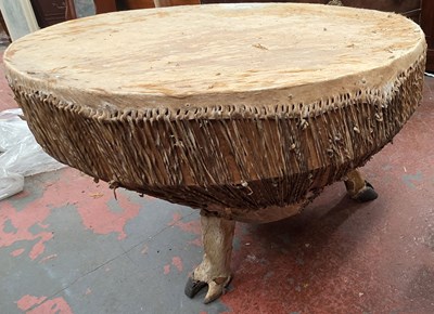 Lot 140 - A large African tribal style drum, with animal...