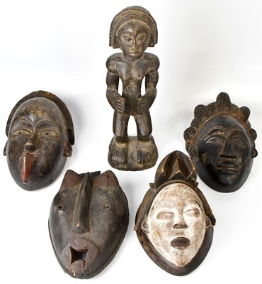 Lot 296 - Four carved tribal masks comprising a white...