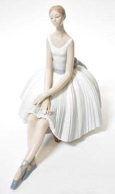 Lot 226 - LLADRÓ; a figure of a seated ballerina, marks...