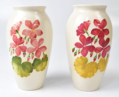 Lot 259 - MOORCROFT; a pair of cream ground 'Geranium'...