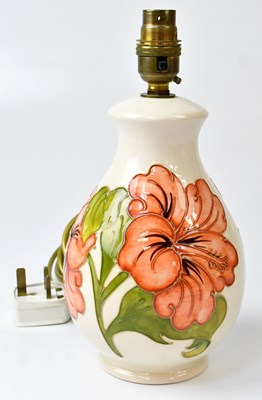 Lot 257 - MOORCROFT; a cream ground 'Hibiscus' pattern...